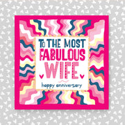 Greeting card with colorful design and text 'To the most fabulous wife, happy anniversary' on a grey background with heart patterns.